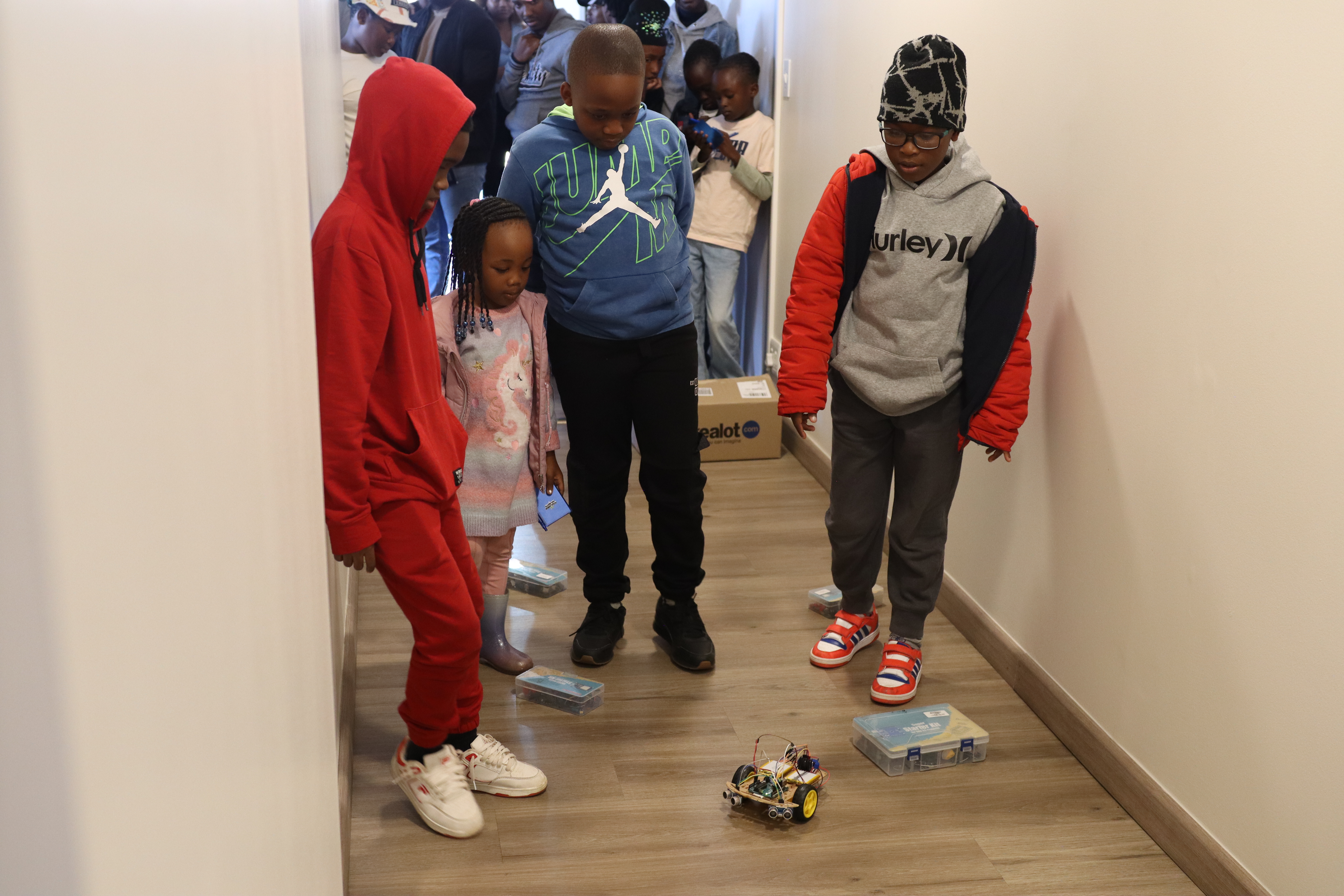 Kids watching a robot in action