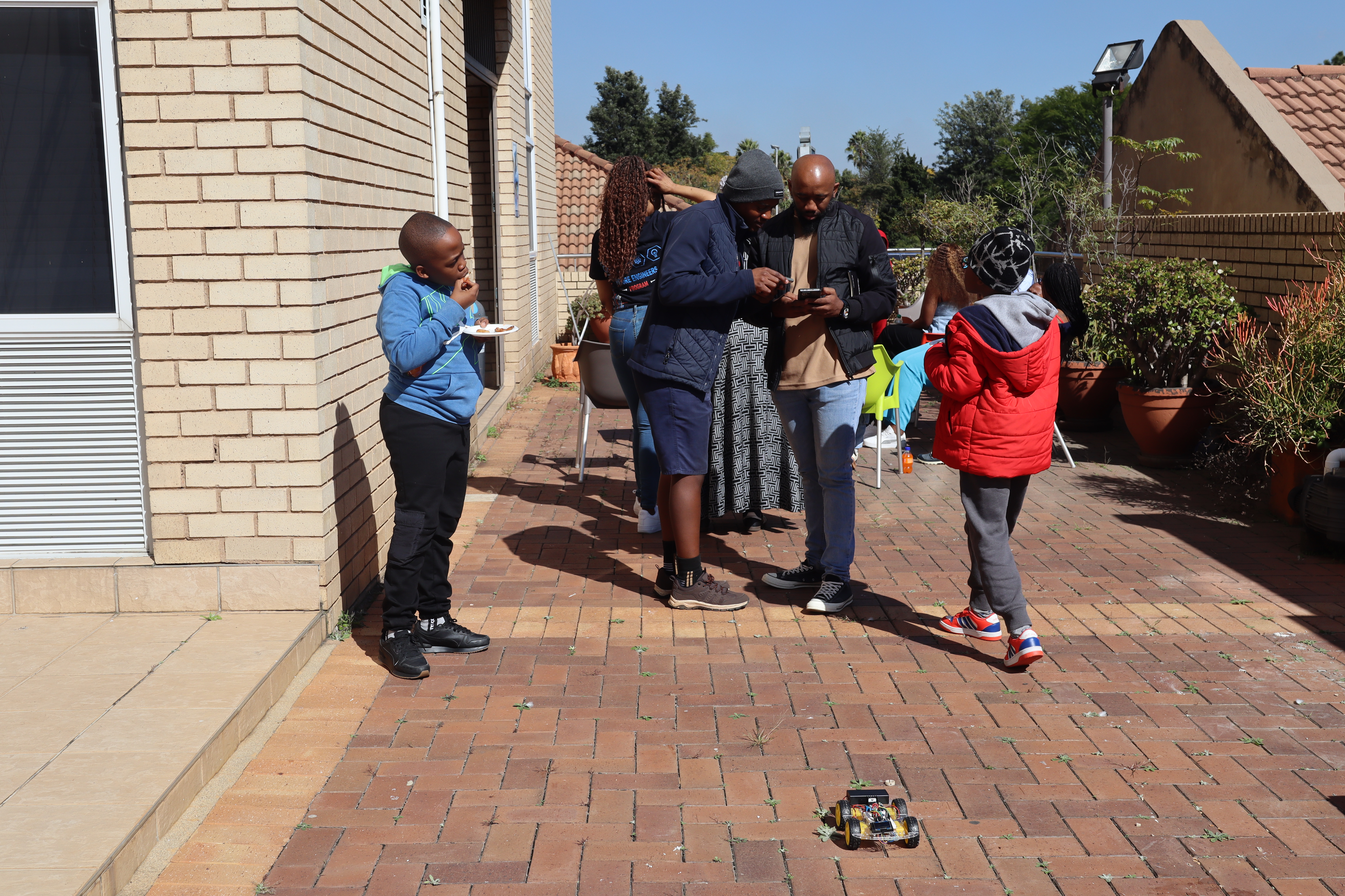Children testing a robot outdoors